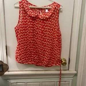 Orange sleeveless bird blouse.